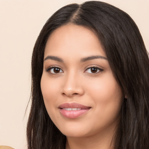 Joyful latino young-adult female with long  black hair and brown eyes