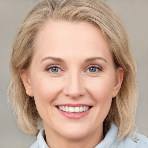 Joyful white young-adult female with medium  brown hair and blue eyes