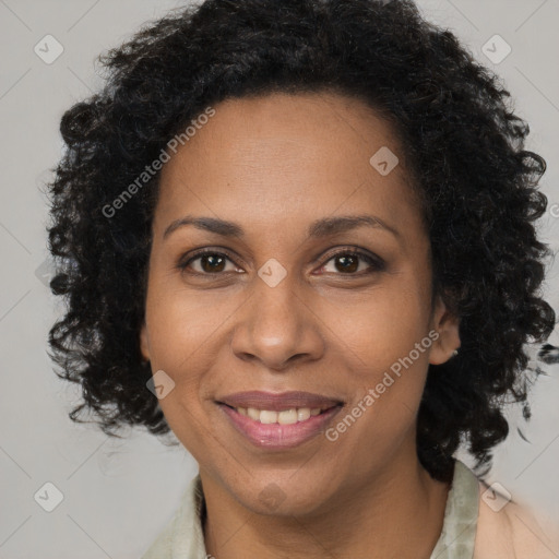 Joyful black adult female with long  brown hair and brown eyes