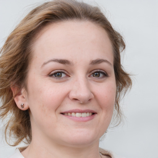 Joyful white young-adult female with medium  brown hair and blue eyes