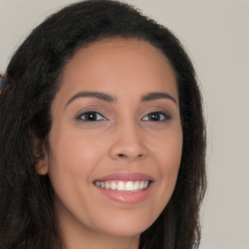 Joyful white young-adult female with long  brown hair and brown eyes