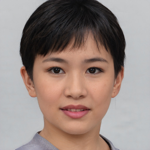 Joyful asian young-adult female with short  brown hair and brown eyes