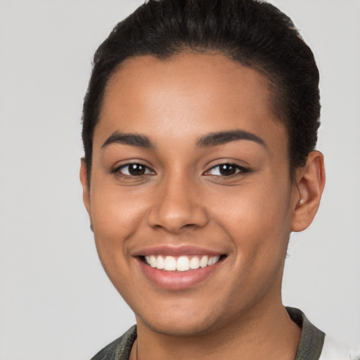 Joyful latino young-adult female with short  brown hair and brown eyes