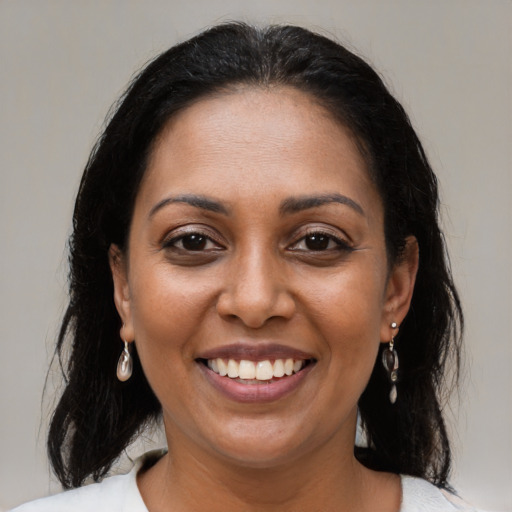 Joyful black young-adult female with medium  brown hair and brown eyes