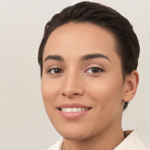 Joyful white young-adult female with short  brown hair and brown eyes