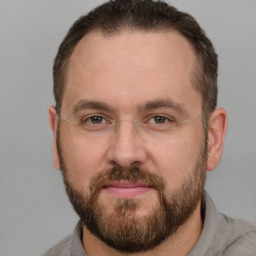 Joyful white adult male with short  brown hair and brown eyes