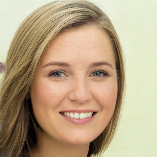 Joyful white young-adult female with long  brown hair and green eyes