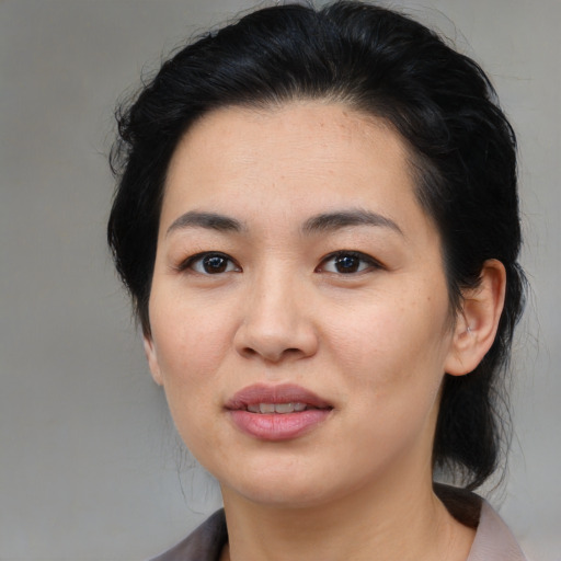 Joyful asian young-adult female with medium  black hair and brown eyes