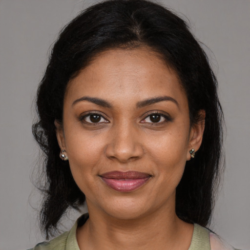 Joyful black young-adult female with medium  brown hair and brown eyes