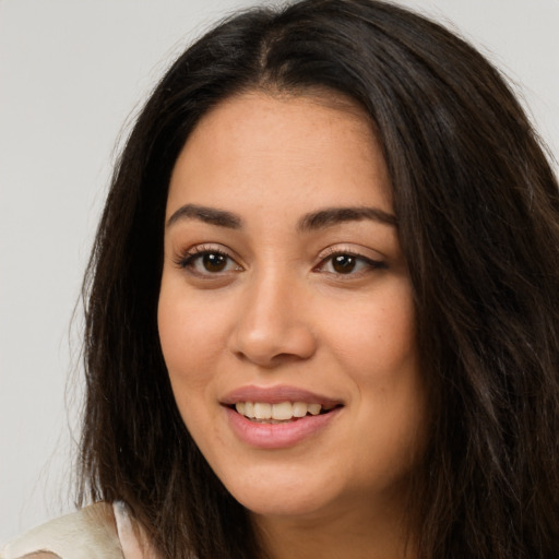 Joyful white young-adult female with long  brown hair and brown eyes