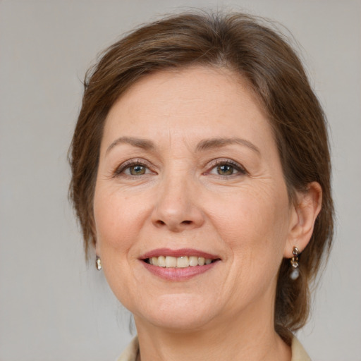 Joyful white adult female with medium  brown hair and brown eyes