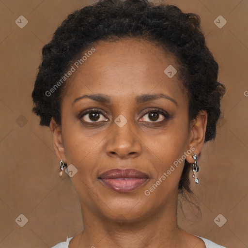 Joyful black adult female with long  brown hair and brown eyes