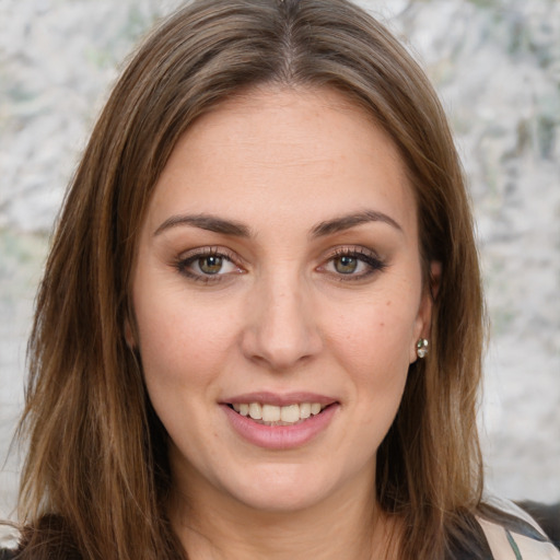 Joyful white young-adult female with long  brown hair and green eyes