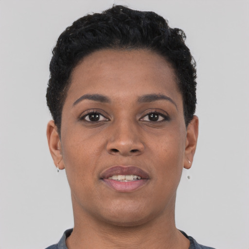 Joyful black young-adult female with short  brown hair and brown eyes