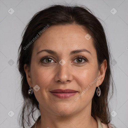 Joyful white adult female with medium  brown hair and grey eyes