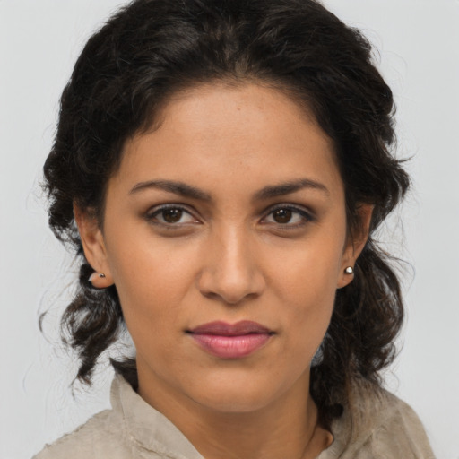 Joyful latino young-adult female with medium  brown hair and brown eyes