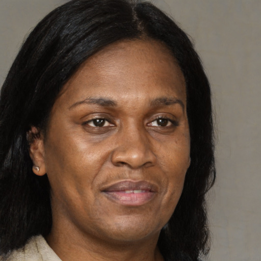 Joyful black adult female with medium  brown hair and brown eyes