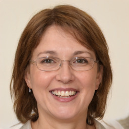 Joyful white adult female with medium  brown hair and blue eyes