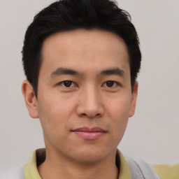 Joyful asian young-adult male with short  black hair and brown eyes