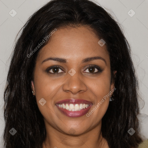 Joyful black young-adult female with long  brown hair and brown eyes