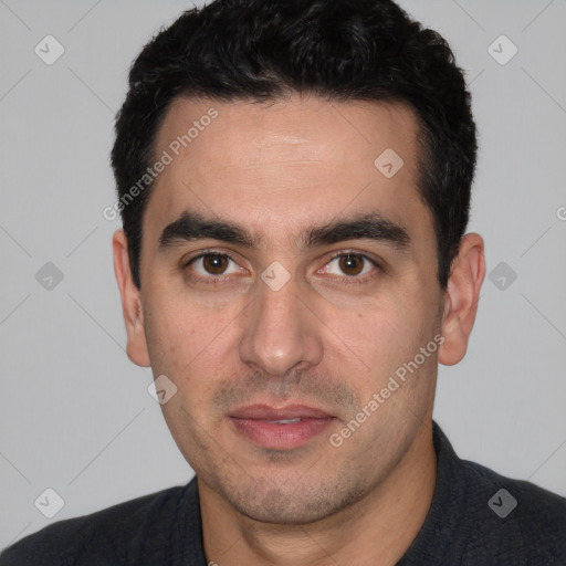 Joyful white young-adult male with short  black hair and brown eyes