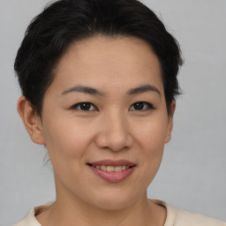 Joyful asian young-adult female with short  brown hair and brown eyes