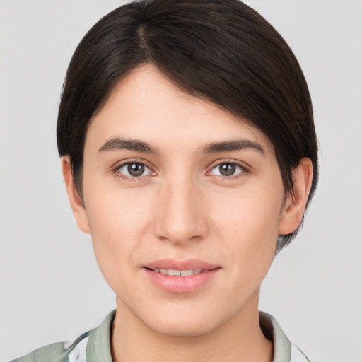 Joyful white young-adult female with short  brown hair and brown eyes