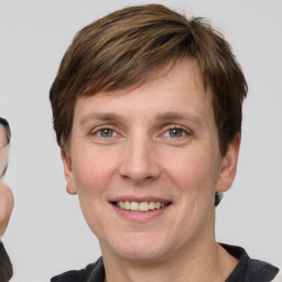 Joyful white adult male with short  brown hair and grey eyes