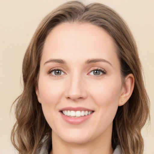 Joyful white young-adult female with medium  brown hair and green eyes