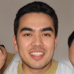 Joyful latino young-adult male with short  brown hair and brown eyes