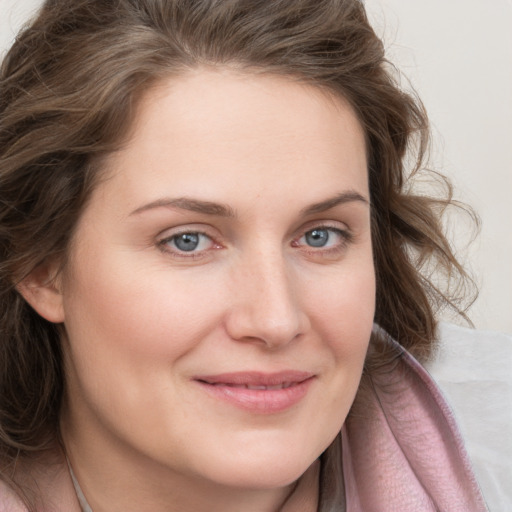 Joyful white young-adult female with medium  brown hair and blue eyes