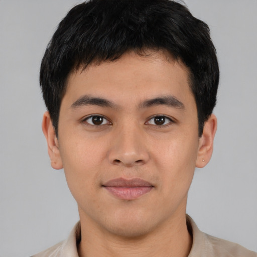 Joyful asian young-adult male with short  black hair and brown eyes
