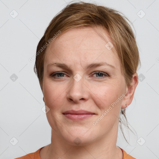 Joyful white adult female with short  brown hair and grey eyes