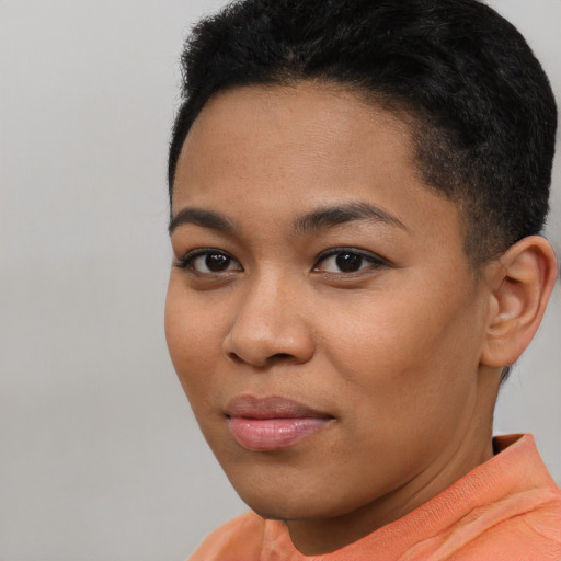 Joyful latino young-adult female with short  brown hair and brown eyes