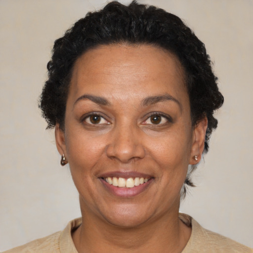 Joyful black adult female with short  brown hair and brown eyes