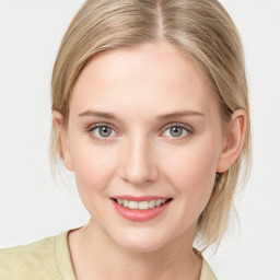 Joyful white young-adult female with medium  brown hair and blue eyes