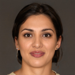 Joyful white young-adult female with medium  brown hair and brown eyes