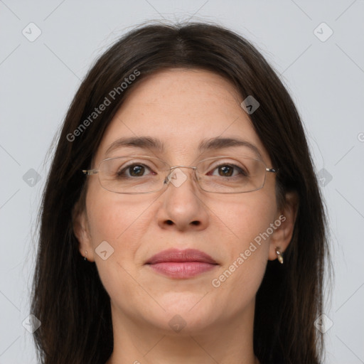 Joyful white adult female with long  brown hair and grey eyes