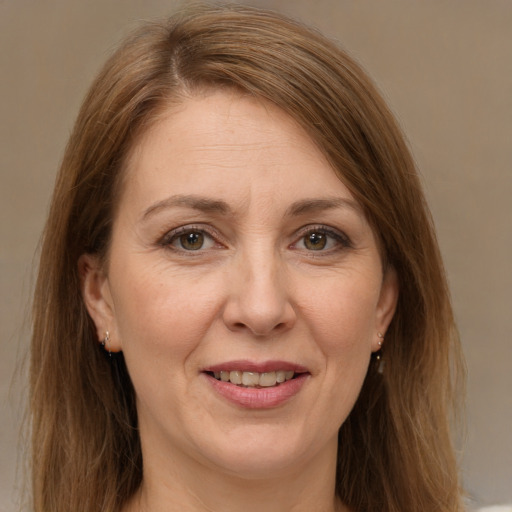 Joyful white adult female with medium  brown hair and brown eyes