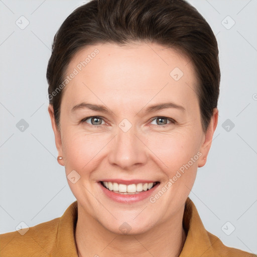 Joyful white adult female with short  brown hair and grey eyes