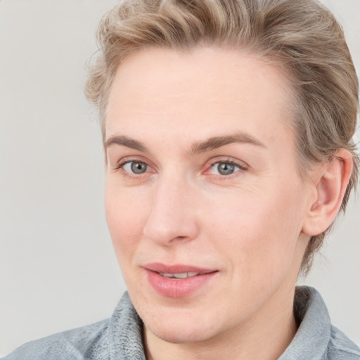 Joyful white young-adult female with short  brown hair and blue eyes