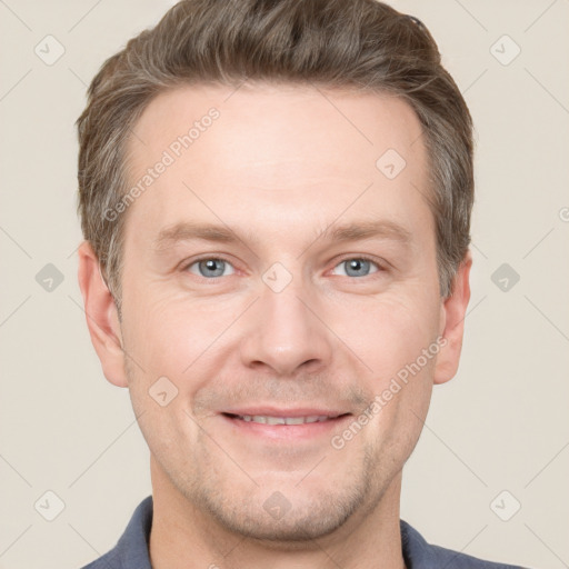 Joyful white adult male with short  brown hair and grey eyes