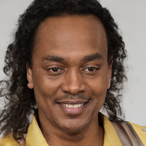 Joyful black adult male with short  brown hair and brown eyes