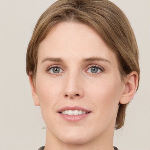 Joyful white young-adult female with medium  brown hair and green eyes