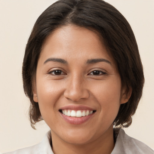 Joyful white young-adult female with medium  brown hair and brown eyes