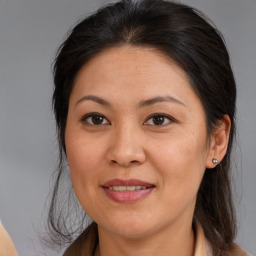 Joyful white adult female with medium  brown hair and brown eyes