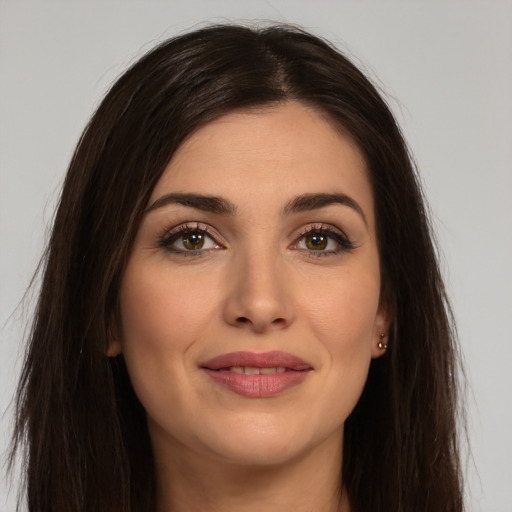 Joyful white young-adult female with long  brown hair and brown eyes