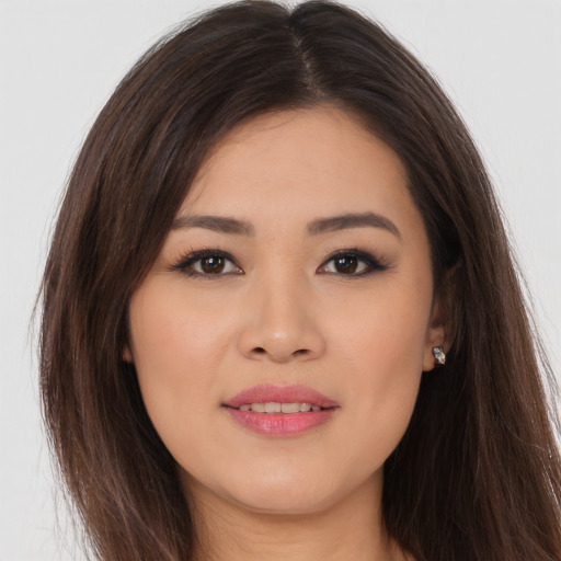Joyful asian young-adult female with long  brown hair and brown eyes