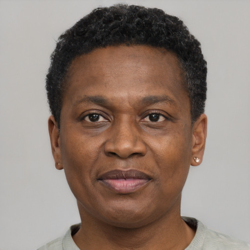 Joyful black adult male with short  black hair and brown eyes