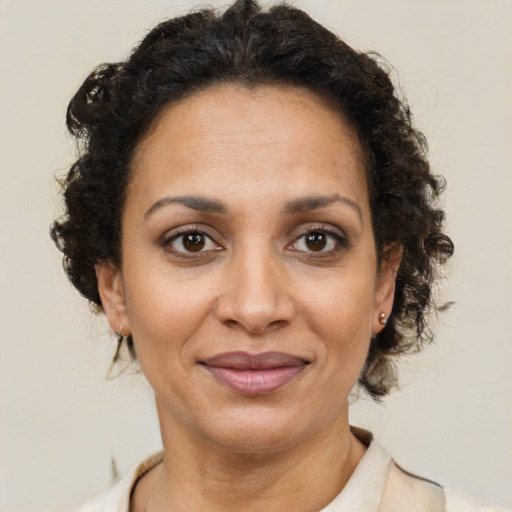 Joyful latino adult female with short  brown hair and brown eyes